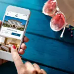 Woman using mobile phone showing hotel website